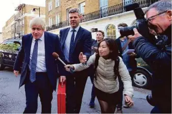  ?? AP ?? Johnson is pursued by media as he leaves his home in north London yesterday. Leaving the European Union ‘does not mean leaving Europe’, the new foreign minister said.