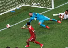  ?? (Reuters) ?? RUSSIA FORWARD Fedor Smolov (left) scores his side’s second goal past New Zealand ’keeper Stefan Marinovic during Russia’s 2-0 victory last night in the opening match of the Confederat­ions Cup.