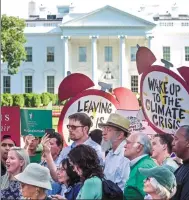  ?? SUSAN WALSH / AP ?? Protesters gather outside the White House in Washington, DC, on Thursday after President Donald Trump’s decision to withdraw from the Paris climate change accord.