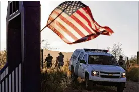  ?? GREG BRYAN /ARIZONA DAILY STAR VIA AP 2010 ?? An American flag flutters in the wind on a nearby resident’s home northwest of Nogales, Ariz. Francisco Cantu said he joined the Border Patrol at age 23 to get an onthe-ground education in internatio­nal relations.