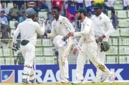  ??  ?? Zimbabwe cricketer Brandon Mavuta (2nd L) celebrates with his teammate Regis Chakabva (L) as Sikandar Raza (2nd R), captain Hamilton Masakadza (R) look on after winning the first Test cricket in Sylhet yesterday.