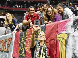  ?? HYOSUB SHIN / HYOSUB.SHIN@AJC.COM ?? Defender Franco Escobar takes a selfie with fans after Atlanta United defeated New England in the first round of the MLS playoffs Saturday.