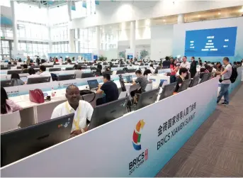  ??  ?? Aly Diouf, a journalist with the Senegalese newspaper Le Soleil, covers the Ninth BRICS Summit in Xiamen on a China-africa media exchange project in September 2017