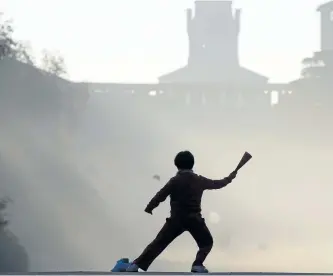  ?? LUCA BRUNO/ THE ASSOCIATED PRESS ?? A woman practices tai chi in front of the Sforzesco Castle at the Sempione park in Milan, Italy. Exercisers tend to spend most of their time indoors at this time of year, but workouts spent staring at four walls pale in comparison to working up a sweat...