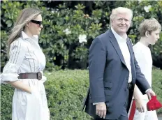  ?? CAROLYN KASTER/THE ASSOCIATED PRESS ?? U.S. President Donald Trump, first lady Melania Trump, and their son and Barron Trump, walk to Marine One across the South Lawn of the White House in Washington, on Saturday, en route to Camp David in Maryland.