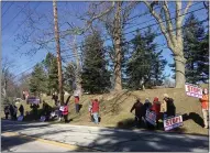  ?? BILL DEBUS - THE NEWS-HERALD ?? Protesters gather along Kirtland Road on the morning of March 13to protest weekend skeet shooting that takes place every November through March at Kirtland Country Club in Willoughby. Residents in the vicinity of the club, which is located on Kirtland Road, claim that the skeet shooting has caused excessive noise and should be discontinu­ed.