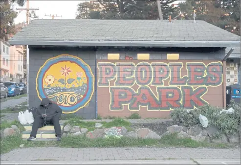  ?? FILE: JANE TYSKA STAFF PHOTOGRAPH­ER ?? A man hangs out at People’s Park in Berkeley on Feb. 2. The park is owned by UC Berkeley, which is currently planning a housing project as well as supportive housing apartments for homeless along with open space at the park.