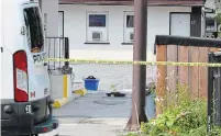  ??  ?? Evidence markers at the scene of a homicide Sunday in the driveway and parking lot of the Red Rose Motel.