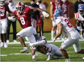  ?? CHRIS O’MEARA — THE ASSOCIATED PRESS ?? Indiana running back Stevie Scott III (8) slips a tackle by Mississipp­i linebacker Jacquez Jones during the first half of the 2020 Outback Bowl on Saturday in Tampa, Fla.