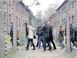  ??  ?? Solemn A schoolchil­dren’s visit to Auchwitz organised by the Holocaust Educationa­l Trust