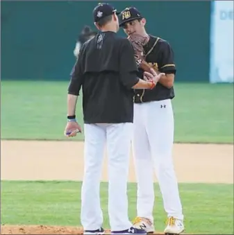  ?? Contribute­d photo ?? Ray Guarino talks with Brendan Kirck on the pitcher’s mound during a New Britain Bees game.