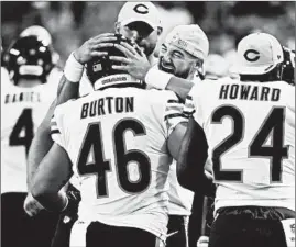  ?? CHRIS SWEDA/CHICAGO TRIBUNE ?? Stressing leadership, Mitch Trubisky hugs Michael Burton after a Burton preseason TD.