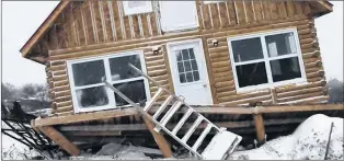  ?? SUBMITTED PHOTO ?? Strong winds knocked this log cabin, near Lumsden, off its shores Nov. 15. Wind gusts throughout the central Newfoundla­nd region peaked in Twillingat­e at 143 km/h.