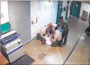  ?? ?? L.A. COUNTY Sheriff ’s Deputy Doug Johnson kneels on an inmate’s head while subduing him.