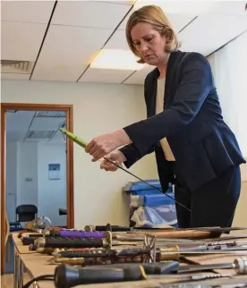  ??  ?? Surge: Home Secretary Amber Rudd examines seized knives