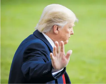  ?? Photo / AP ?? President Donald Trump walks to the Marine One helicopter after speaking to journalist­s.