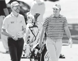  ?? Curtis Compton / Tribune News Service ?? A day after winning the Valero Texas Open for his first victory in nearly four years, there are no signs of stress for Jordan Spieth, right, as he joins Jimmy Walker on the practice range at Augusta.