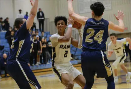  ?? OWEN MCCUE (ABOVE), AUSTIN HERTZOG (BELOW) - MEDIANEWS GROUP ?? Above, Spring-Ford’s Tre Medearis, center, surveys the floor as Upper Merion’s Chaz Clark, left, and Nick Shepperd defend. Below, Boyertown’s Aarick Salata, right, and Phoenixvil­le’s Clay Kopko, left, fall to the floor after a collision Wednesday in a PAC playoff game at Spring-Ford.