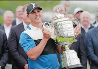  ?? JULIO CORTEZ/AP PHOTO ?? Brooks Koepka holds up the Wanamaker Trophy after winning the PGA Championsh­ip on Sunday at Bethpage Black in Farmingdal­e, N.Y.