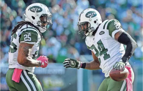  ?? ALEX GOODLETT, GETTY IMAGES ?? Cornerback Darrelle Revis, right, had his third intercepti­on of the season Sunday in the Jets’ 34-20 win against the Redskins.