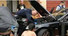  ?? PHOTO: JOHNATHAN NG ?? SENDING A MESSAGE: NSW police search a car during the weekend raids in Sydney.