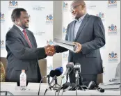  ?? PICTURE: MOTSHWARI MOFOKENG ?? ROAD AHEAD: Premier of Gauteng David Makhura receives the e-toll advisory report from Professor Muxe Nkondo, who headed the panel that was establishe­d in July to assess the socio-economic impact of e-tolls in the province.