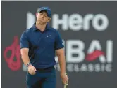  ?? KAMRAN JEBREILI/AP ?? Rory McIlroy reacts after missing a ball on the 18th during the second round of the Dubai Desert Classic on Saturday in Dubai, United Arab Emirates.