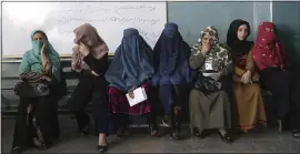  ?? PHOTOS BY THE ASSOCIATED PRESS ?? Afghan women wait for a polling station to open so they can vote in the presidenti­al election in Kabul, Afghanista­n, on Saturday.