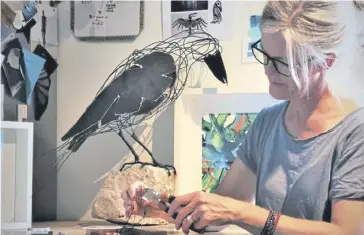  ?? ?? Deborah Hochreuten­er sculpting a crow