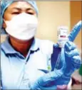  ?? HENG CHIVOAN ?? A medical worker prepares to administer a Covid jab at Chbar Ampov Referral Hospital in the capital.