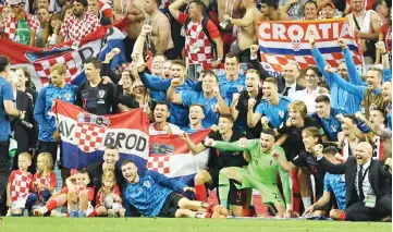  ??  ?? Croatia’s players and officials celebrate with fans at the end of the match. — APP photo