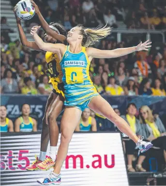 ?? Picture: SARAH MATRAY ?? Australia’s Kate Maloney and Jamaica’s Tishana Hanson fly high yesterday