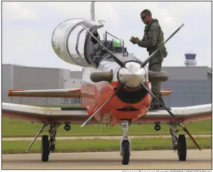  ?? Arkansas Democrat-Gazette/STATON BREIDENTHA­L ?? A pilot exits his T-6 Texan Navy trainer after landing Tuesday at Bill and Hillary Clinton National Airport/ Adams Field. Dozens of the planes were flown in from north of Pensacola to escape Hurricane Michael.