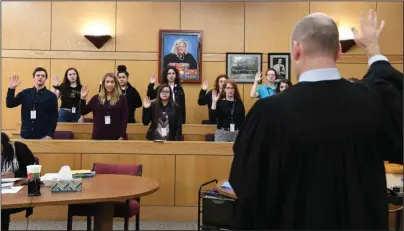  ?? The Sentinel-Record/Grace Brown ?? SWEARING IN: Division 2 Garland County Circuit Court Judge Wade Naramore swears in the jury at the mock trial of Teen Court at the Garland County Courts Building on Monday. Teen Court will try its first real case on Feb. 25.