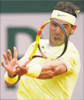  ?? Kenzo Triboullia­rd / AFP / Getty Images ?? Rafael Nadal returns the ball to Kei Nishikori during a quarterfin­al match at the French Open in 2019.