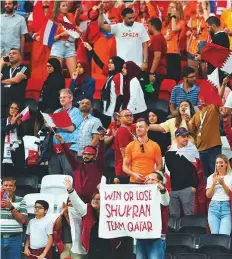  ?? AFP ?? A supporter holds a banner thanking Qatar during the match between the Netherland­s and Qatar at the Al Bayt Stadium.