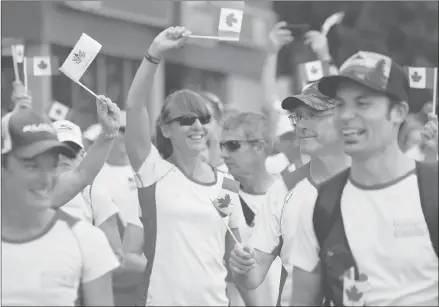  ?? JOE FRIES/Penticton Herald ?? More than 1,000 athletes rumbled down Main Street on Wednesday evening for the Parade of Nations as part of the ITU Multisport World Championsh­ips Festival. Above: a sea of smiling Canucks brought up the rear of the parade.