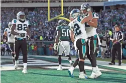  ?? AP ?? Panthers tight end Greg Olsen, right, celebrates his touchdown catch with Christian McCaffrey on Sunday against the Eagles in Philadelph­ia.
