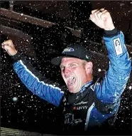  ?? AP/CARLOS OSORIO ?? Clint Bowyer is doused after winning a rain-shortened NASCAR Monster Energy Cup Firekeeper­s Casino 400 on Sunday in Brooklyn, Mich.