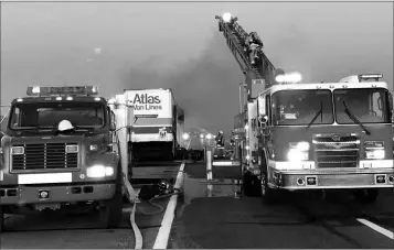  ??  ?? FIREFIGHTE­RS HAD TO CUT OPEN THE ROOF OF THE TRAILER. They were able to douse the fire from above by using the nozzle on the end of the ladder of the ladder truck, eventually putting it out.