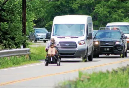  ?? KRISTI GARABRANDT — THE NEWS-HERALD ?? Army Sgt. Joshua Geartz receives a police escort along Wilson Mills Road in Chester Township during his 422-mile journey from Indiana to New York to raise awareness of veteran suicide.