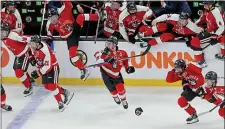  ?? MATT STONE — BOSTON HERALD ?? Northeaste­rn players jump off the bench in celebratio­n after beating Harvard in a shootout in the Beanpot championsh­ip game Monday at the TD Garden. The Huskies have won four of the last five Beanpots.