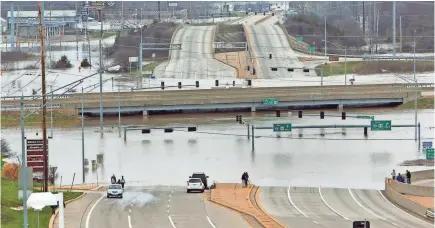  ?? J.B. FORBES/ST. LOUIS POST-DISPATCH VIA AP ?? Floodwater­s from the Meramec River surround a bridge deck in southwest St. Louis County, Mo. The disaster aid package passed by the Senate Thursday includes money for Midwest flood relief.