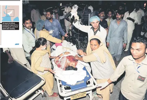 ??  ?? Pakistani relatives and emergency workers carry an injured woman to the hospital in Lahore, after at least 72 people were killed and more than 200 injured when an apparent suicide bomb ripped through the parking lot of a crowded park in the Pakistani...