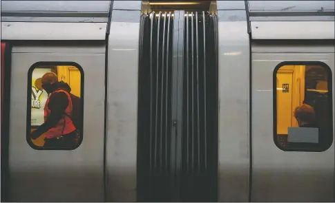  ?? (AP/Alastair Grant) ?? A tube driver walks through the carriages of his train at Edgware Road Undergroun­d station in London.