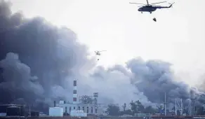  ?? PHOTO: REUTERS ?? Worst in Cuba’s history . . . Helicopter­s drop water over the zone where fuel storage tanks exploded near Cuba’s supertanke­r port in Matanzas. The fire, which began on Saturday, is now under control.