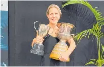  ?? Photo / Supplied ?? Kylie Kirkwood holding her husband’s two trophies.