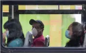  ?? EDUARDO VERDUGO — THE ASSOCIATED PRESS ?? Commuters wear masks as they ride a bus in Mexico City.