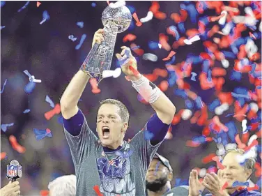  ?? DARRON CUMMINGS/ASSOCIATED PRESS ?? Tom Brady raises the Vince Lombardi Trophy after his New England Patriots rallied to beat the Atlanta Falcons in overtime of Super Bowl 51 in Houston. Brady gets to his 10th Super Bowl on Feb. 7, this time with Tampa Bay.