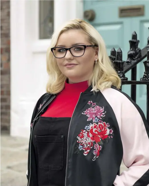  ??  ?? Shannon wears Love Moschino 03, €189 from Specsavers; earrings, €89, Pandora; bomber jacket, €82, M&S; polo neck, €33, Topshop; dungarees, €78, Oasis